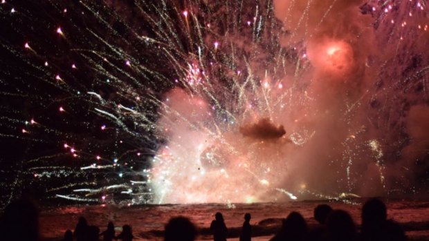 Crowds have been evacuated from Terrigal Beach, after a barge carrying fireworks caught alight during their 9pm show.
