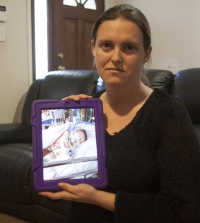 NSW mother Cherie holding a picture of her daugher, who can no longer get medical marijuana