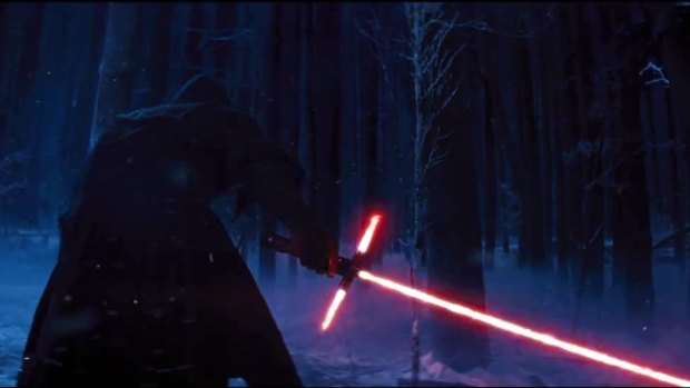 Revenge of the Sith Lords? A figure cloaked in black holds a new lightsaber.