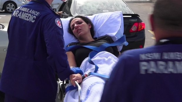 Hoda Darwiche is wheeled away by paramedics after the shooting at Bankstown Central Shopping Centre.