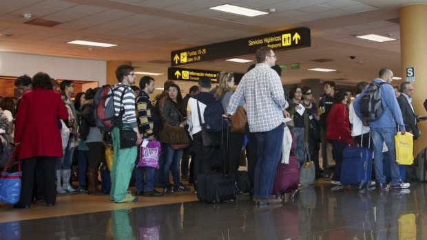 Passengers waiting at airport departure gate at Lima airport, Peru.