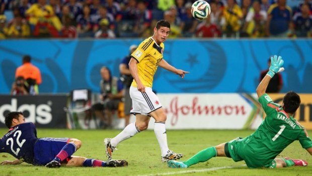 James Rodriguez of Colombia  shoots and scores  his team's fourth goal.