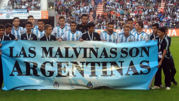 Still a sore point: Argentina's team posing for a picture with a banner reading "The Malvinas are Argentine".
