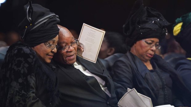 Winnie Mandela hugs then South African president Jacob Zuma after his speech during the funeral service for her former husband Nelson.