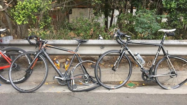 Damaged bikes propped against the road's railings.