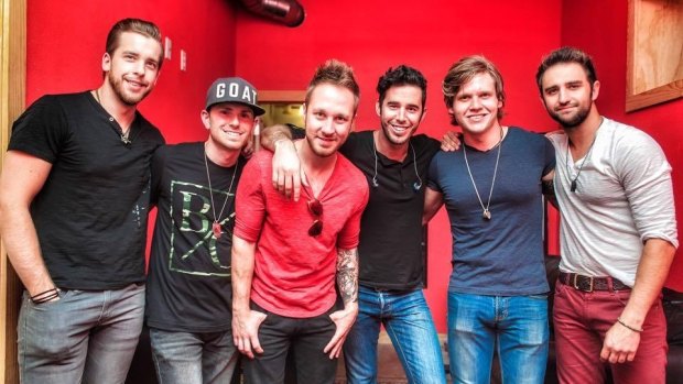 US country music singer Craig Strickland (centre, in black t-shirt and jeans), frontman for band Backroad Anthem, was found dead after going missing in a severe storm.