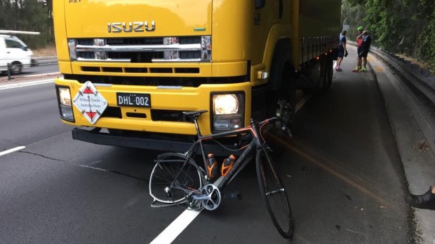 A damaged bike appeared to be wedged under the truck that hit the riders.