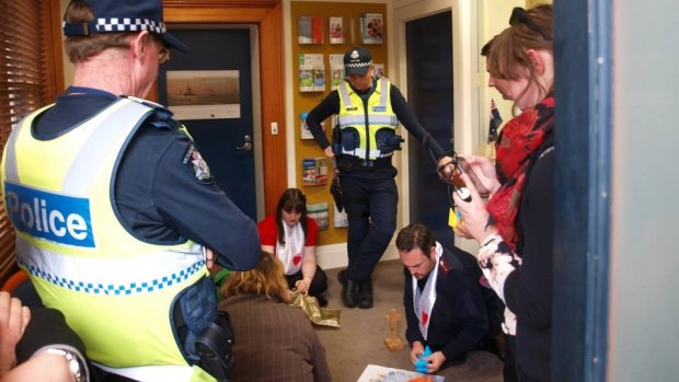 Police watch the "prayer sit-in" inside the Geelong offices of Shadow Immigration Minister Richard Marles.