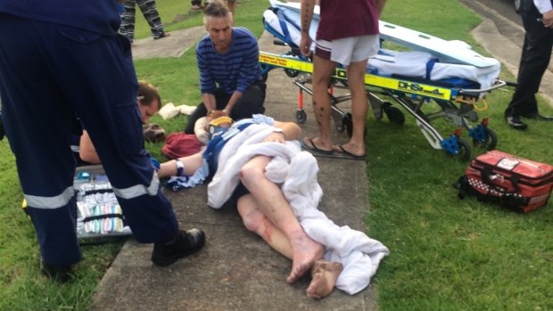 Paramedics attend to Michael Kimmorley after he was hit by a four-wheel-drive.