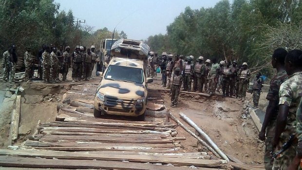 Nigerian troops cross the Kaffin-Hausa bridge, which earlier had been destroyed by terrorists and reconstructed by military engineers at Damasak in north-eastern Nigeria Borno State.  