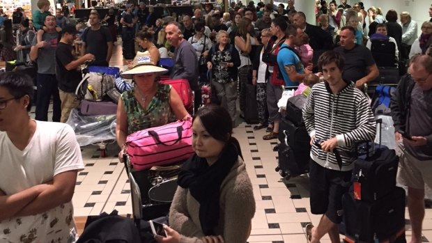 Passengers queue at Brisbane airport on Wednesday night after their Jetstar flight was cancelled after more than 24 hours' delay.