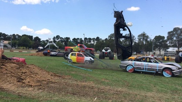 The wreck of a Toyota Rav 4 balances momentarily on Steve "Program'' Ellis's Mitsubishi Magna after he crashed into it for the media on Thursday at EPIC.