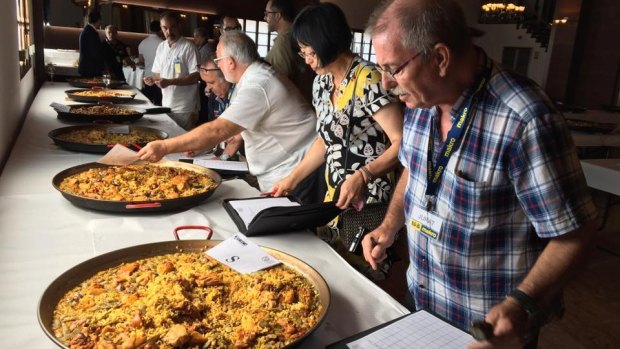 Judges at the the 'Concurso Internacional de Paella' test the dishes on offer 