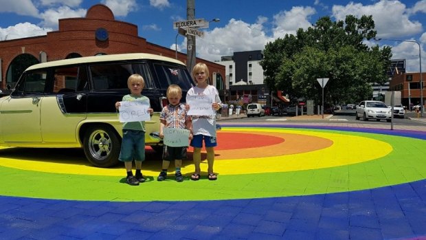 The Belconnen Miller brothers Oscar, six, Magnus, four, and Erik, eight, with their family car, a 1959 Holden FC station wagon, were with dad Tim in Braddon on Thursday to show their support for keeping the informal cruise down Lonsdale Street open during Summernats.