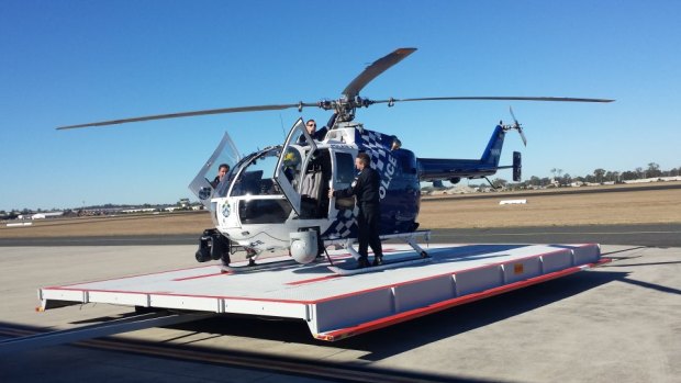 Polair 2 lands at Archerfield Airport on Tuesday morning.