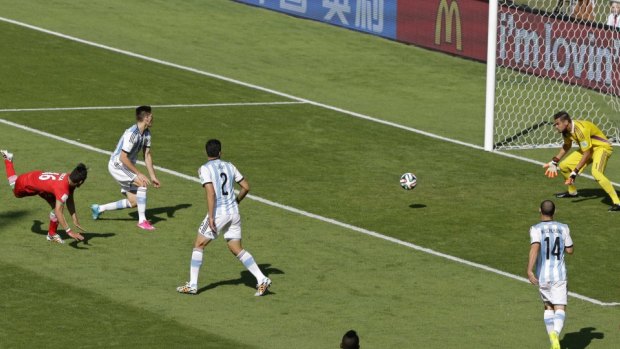Close call: Argentina's goalkeeper Sergio Romero blocks the ball after a header from Iran's Reza Ghoochannejhad.