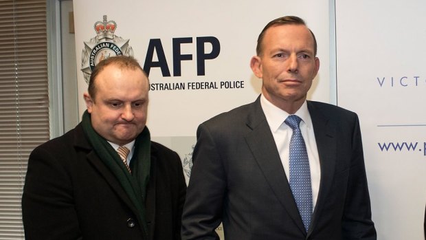 Prime Minister Tony Abbott meets with police in Melbourne on Friday. 