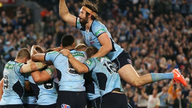 The wait is over: NSW players celebrate the only try of the match.