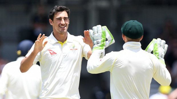 Australian bowler Mitchell Starc reacts after dismissing England batsman Jonny Bairstow (left) for 119 runs on Day 2 of the Third Ashes Test match between Australia and England at the WACA ground in Perth