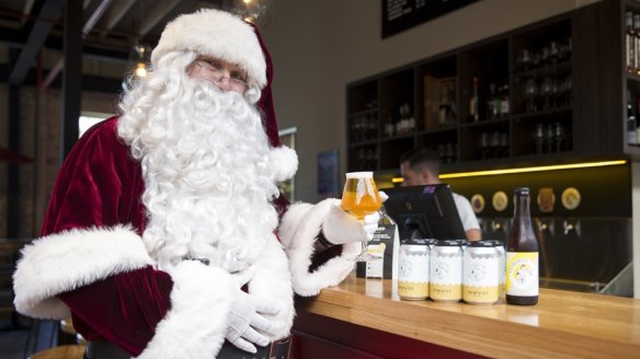 Santa drinking a coldie at the Cannery Christmas Markets.