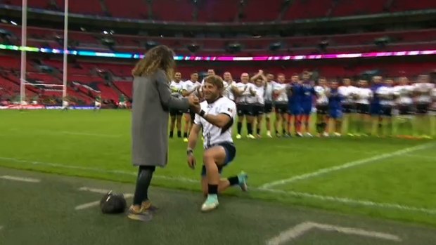 Down on one knee: Florin Surugiu proposes to his girlfriend at Wembley.