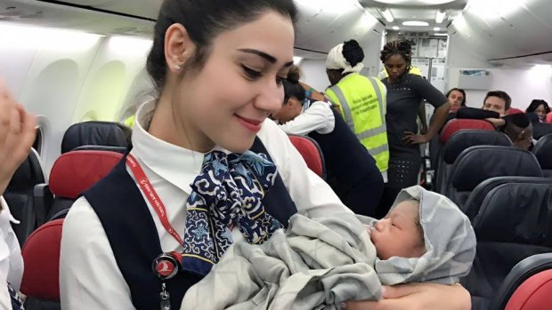 Turkish Airlines cabin crew pose with newborn Kadiju. 