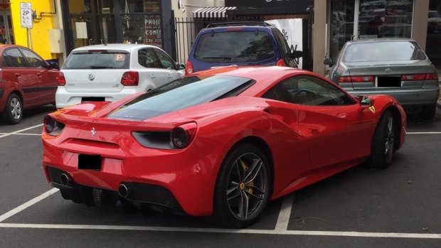 A Ferrari parked across multiple spaces in Kew.