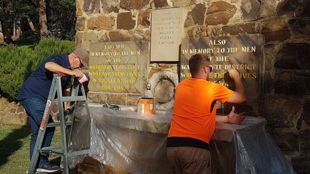 Stephen Papal and his son Ben repair the memorial in time for Anzac Day.