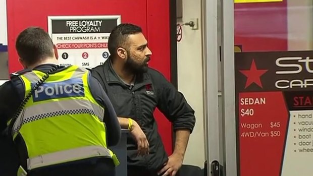 Car wash manager Prince Singh speaks with police after his cousin was stabbed by a thief.