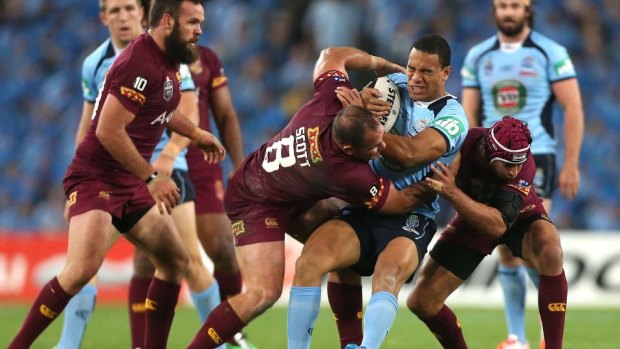 Feeling the pinch: Will Hopoate is dumped by Matt Scott and Johnathan Thurston in game two last year.