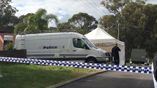 Police forensic officers at the Orelia home where Aaron Pajich's body was found.