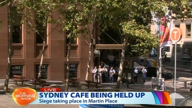 Police with guns drawn in Martin Place in a screengrab.