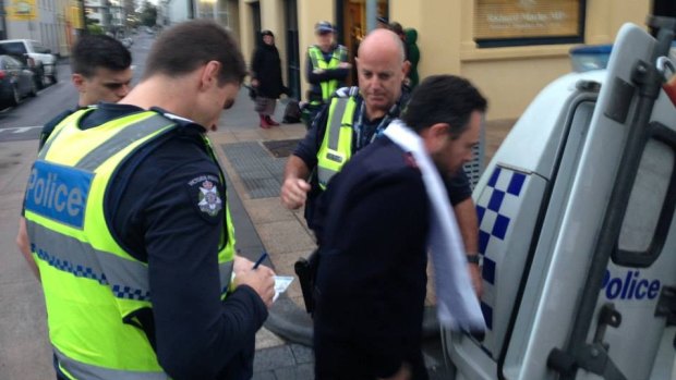 Salvation Army Captain Craig Farrell is taken away by police.