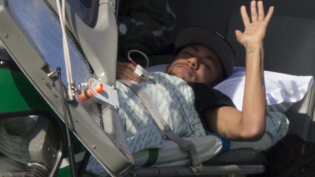 Dream continues: Neymar waves as he lies inside a medical helicopter.