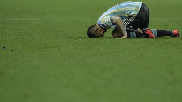 Shattered: Argentina's defender Marcos Rojo reacts after the second half of extra time.
