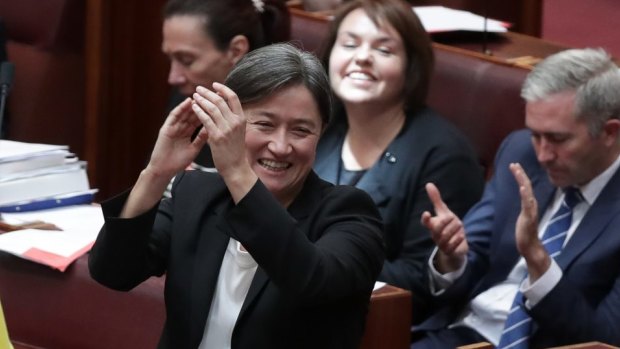 Senator Penny Wong claps as the Marriage Amendment Bill passes the Senate.