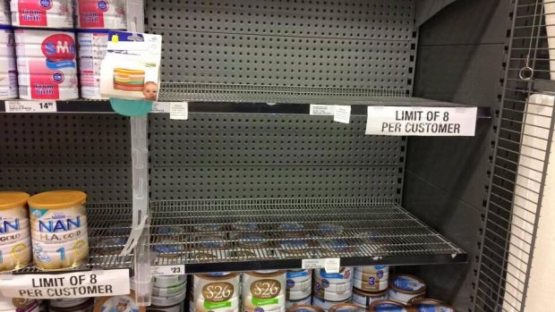 A Woolworths shelf emptied of popular Australian brands. It's imposed an eight-tin limit.