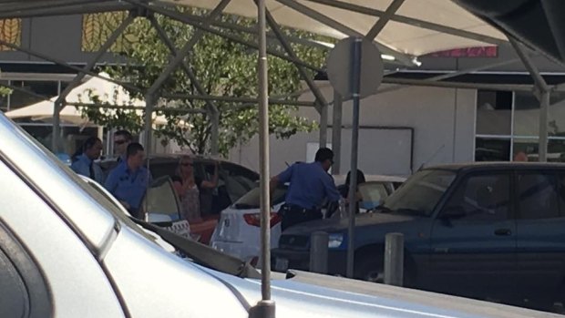 Police work to free a baby left inside a car at Ellenbrook shops. 
