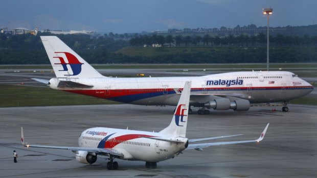 Malaysia Airlines aircrafts taxi on the runway at Kuala Lumpur International Airport. 