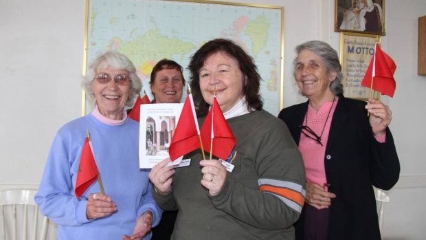 Marion Collier, in the middle holding two flags, in happier times at a CWA fundraiser  at Wellington, NSW, in 2013.