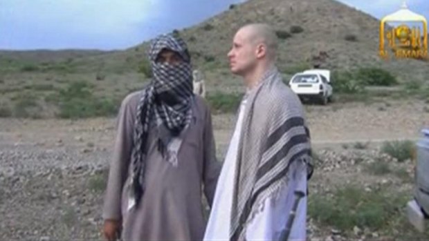 Bowe Bergdahl waits before being released at the Afghan border.