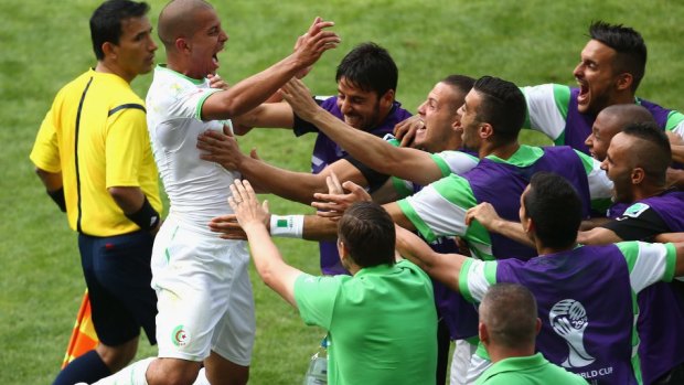 Sofiane Feghouli of Algeria celebrates with his teammates after scoring from the spot.
