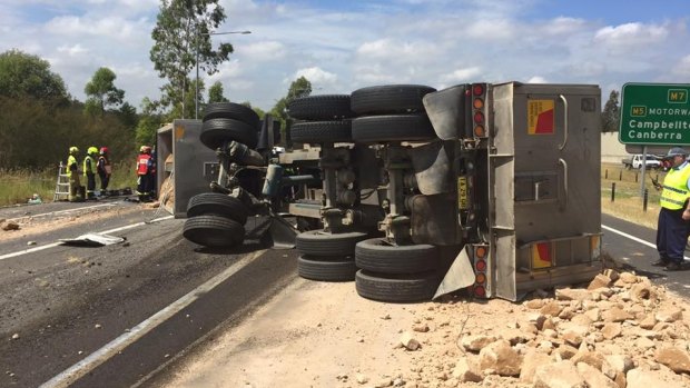 The truck was carrying a load of sand and rocks, which spilled onto the M7.
