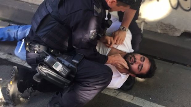Police arrest Saeed Noori in Flinders Street on Thursday.