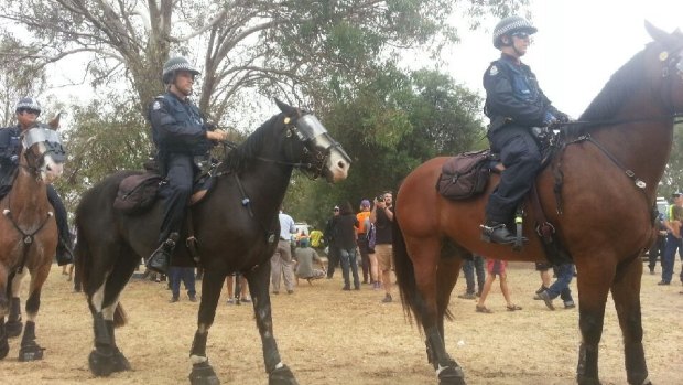 Police on horses move in on Heirisson Island.