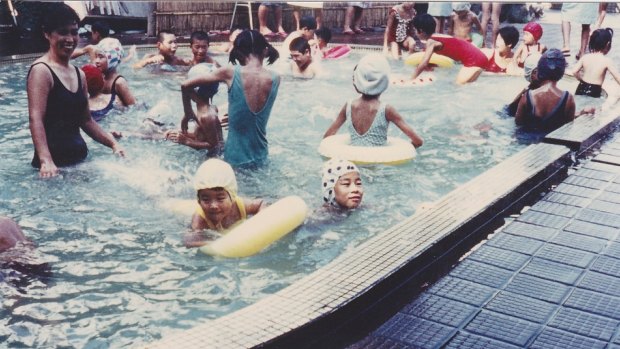 Chieko Ito, top left, with her daughters Chizuko, in a yellow cap, and Eriko, in a white cap with black dots, in 1967.