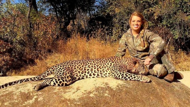 Kendall Jones posing with a leopard -- one of her Facebook photos removed this weekend.