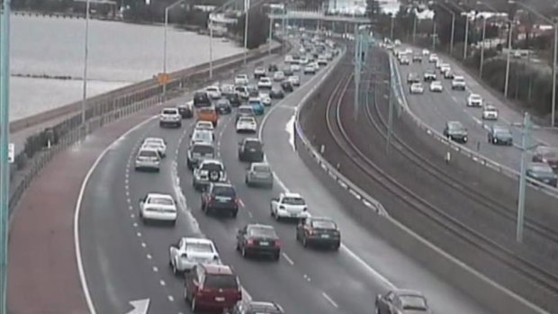 Traffic is heavy on the Kwinana Freeway southbound after a car rolled.