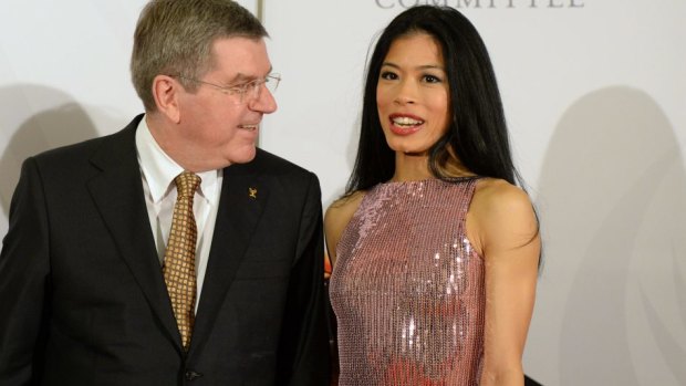 President of the International Olympic Committee Thomas Bach chats with Vanessa Mae at the IOC Gala Dinner in Sochi.