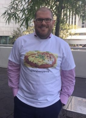 Stephen Humphreys is searching for "Brisbane's Best Parma". He is pictured in a shirt made for him as a Secret Santa present.